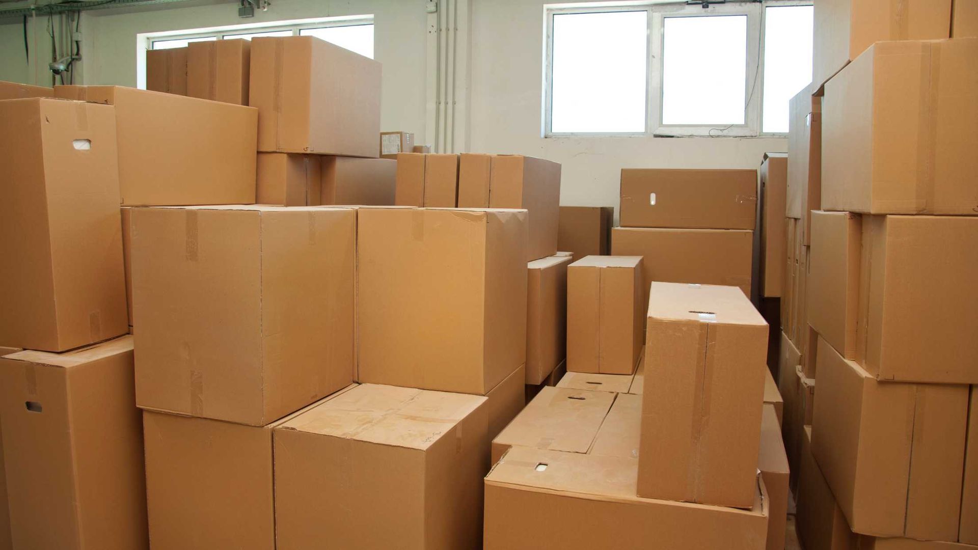 A warehouse filled with lots of cardboard boxes