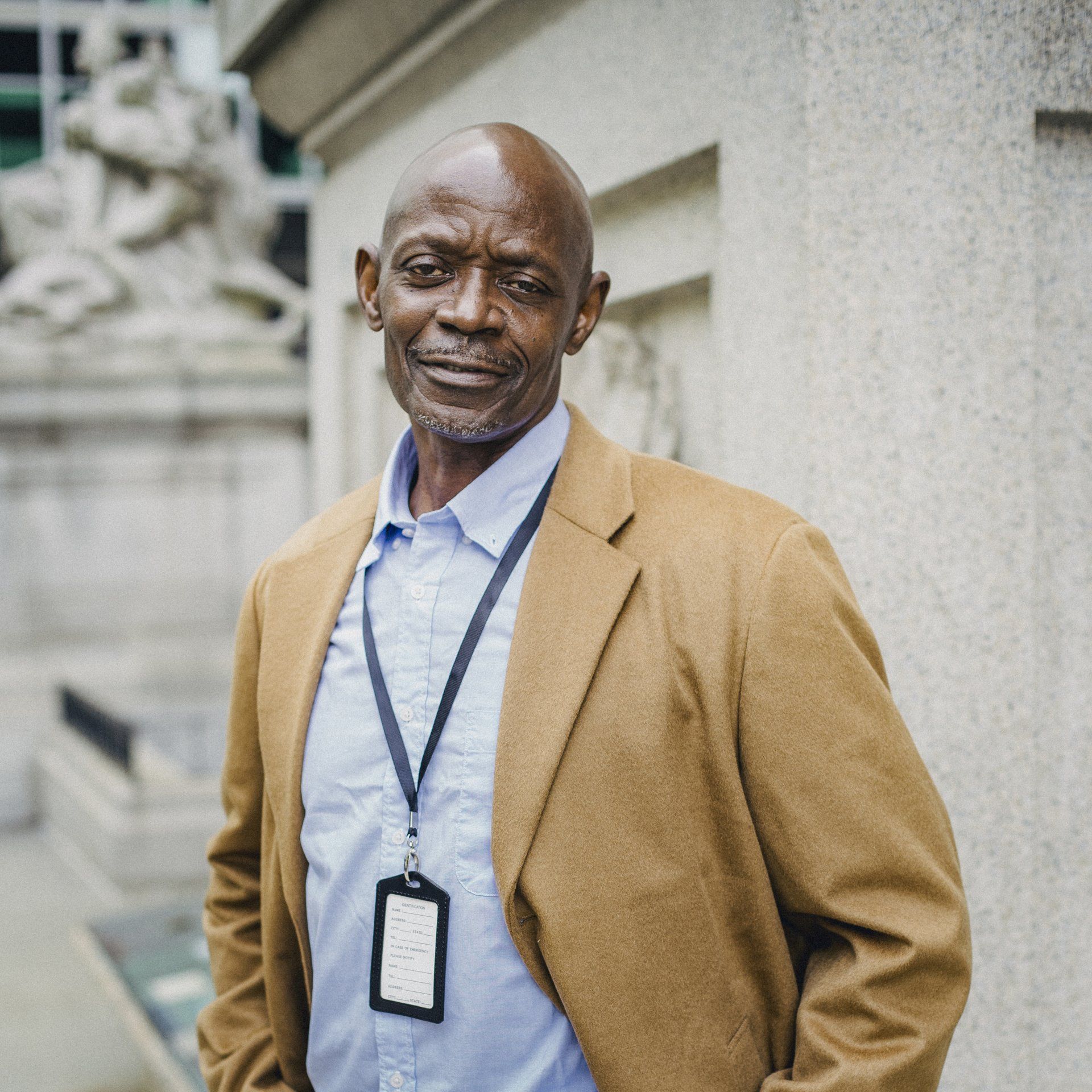 A man wearing a lanyard with a name tag that says ' johnson ' on it