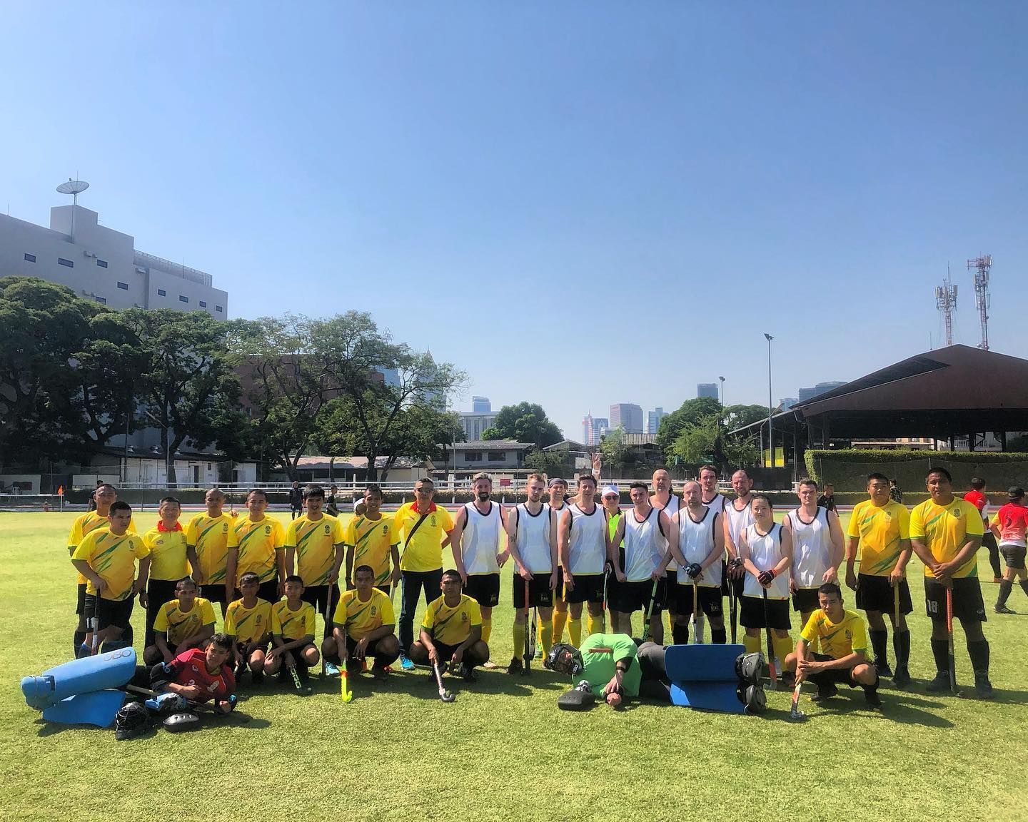 A group of soccer players are posing for a picture on a field.