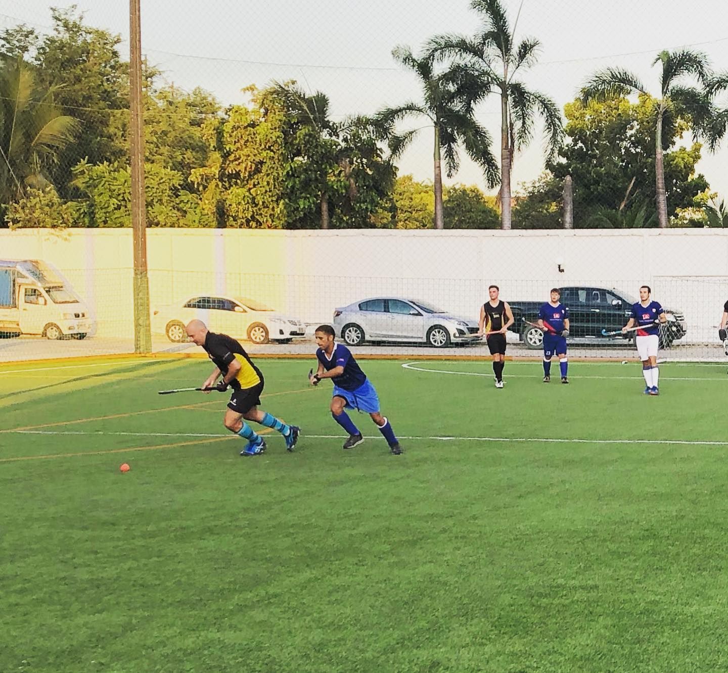 A group of people are playing soccer on a field