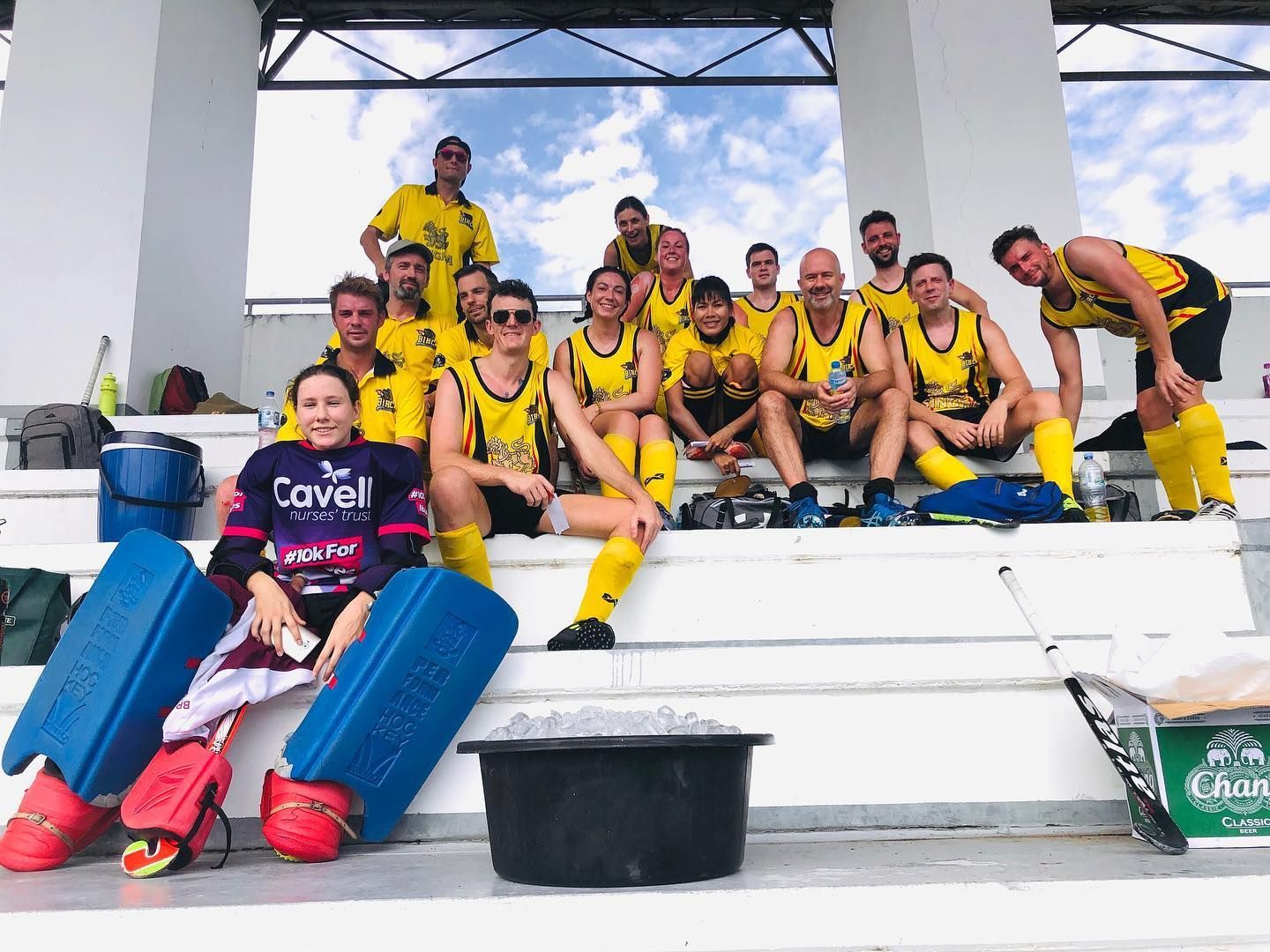 A group of soccer players are posing for a picture on the bleachers.