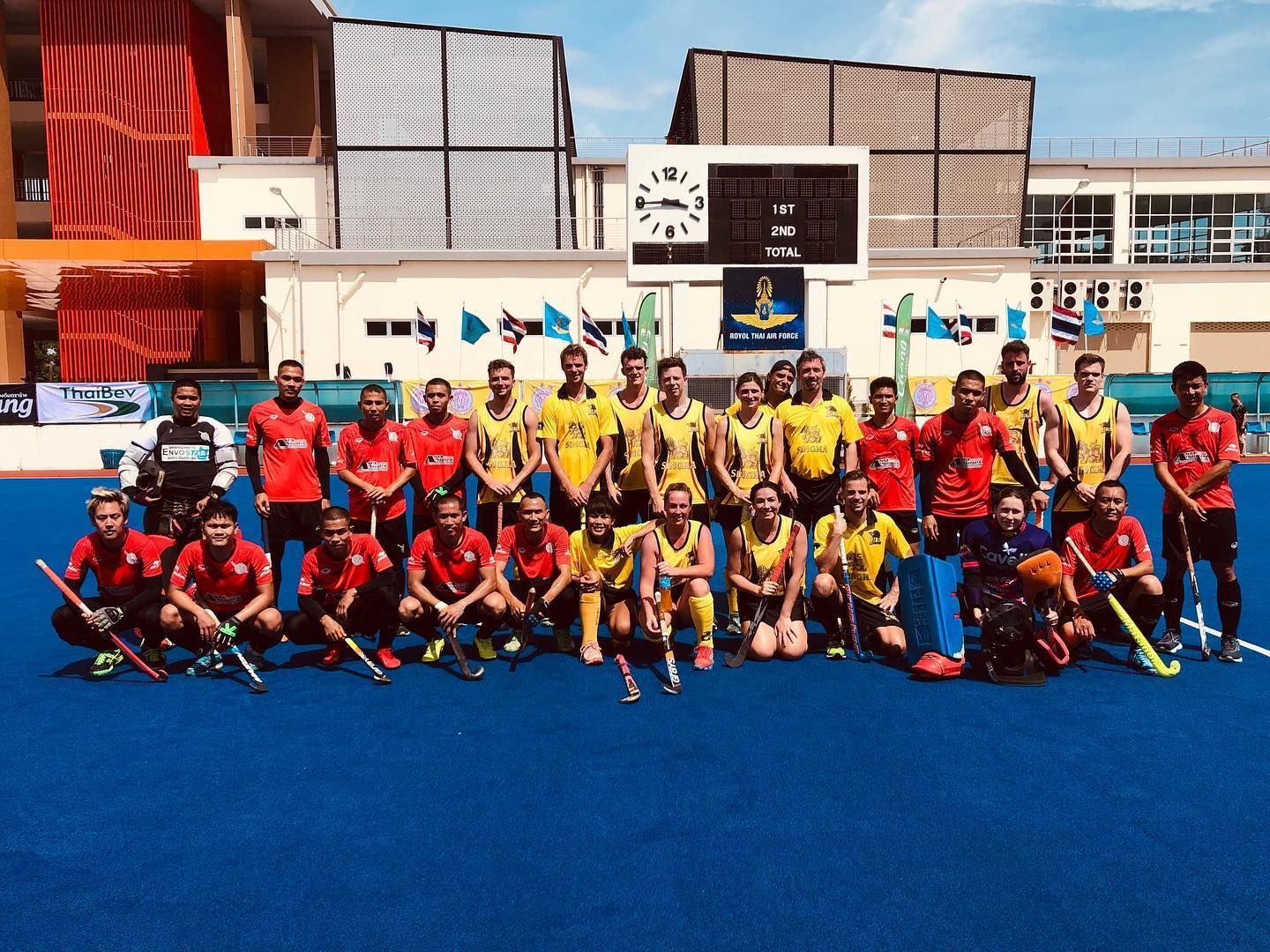A group of people are posing for a picture on a field.