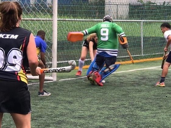 A field hockey player with the number 9 on his jersey