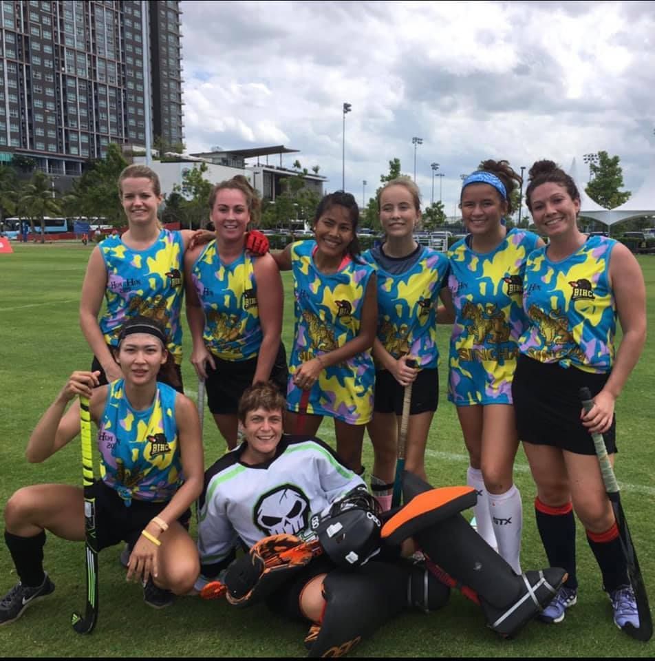 A group of people posing for a picture on a field