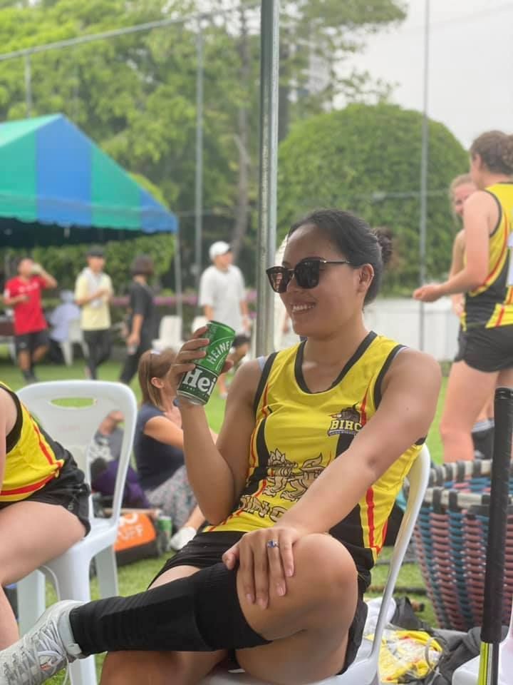 A woman is sitting in a chair holding a can of diet coke.