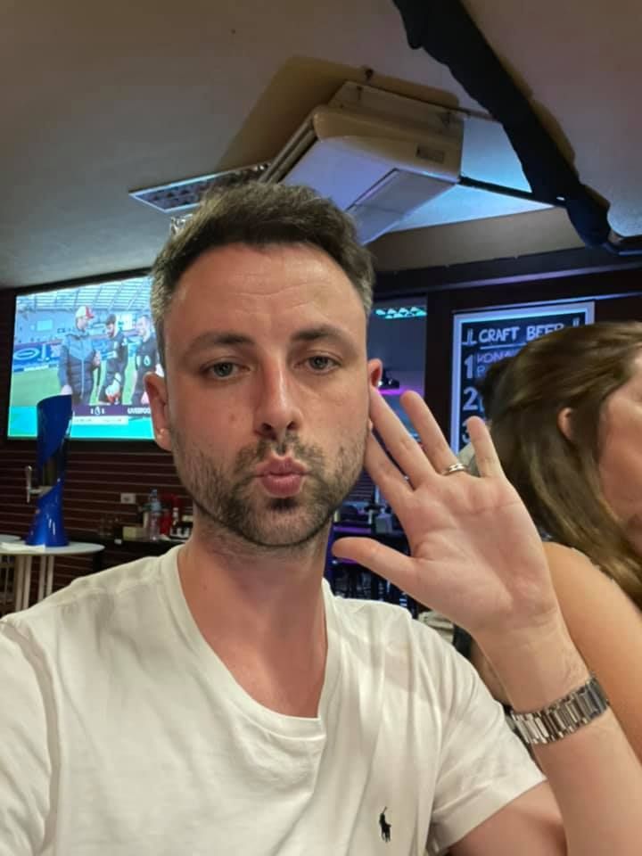 A man in a white shirt is making a funny face