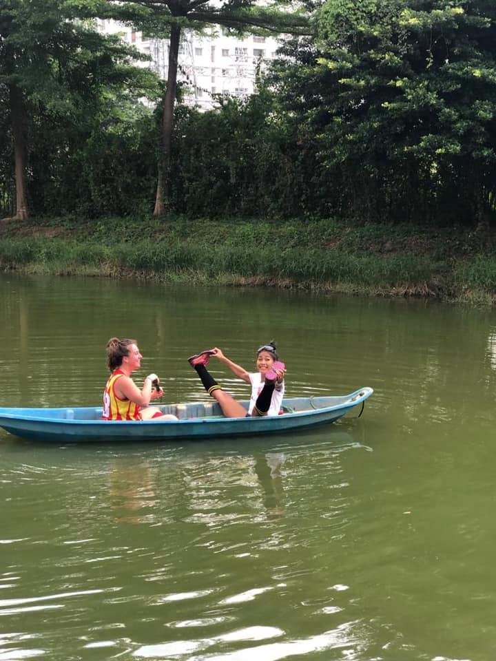 Two people are sitting in a boat on a lake.