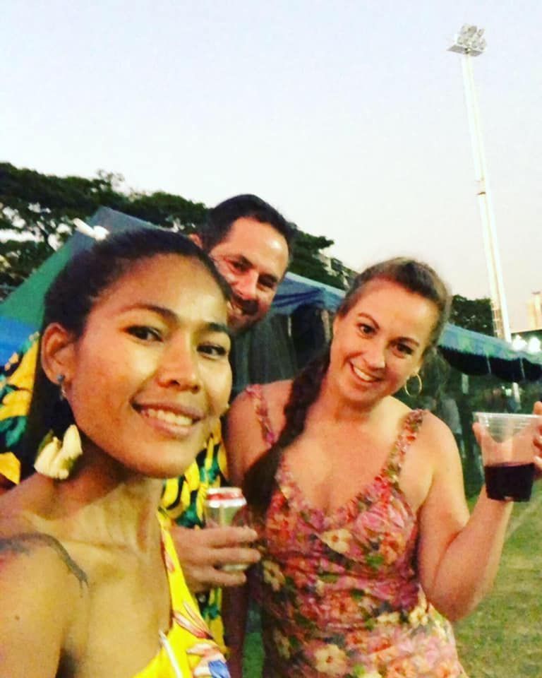 A man and two women are posing for a picture