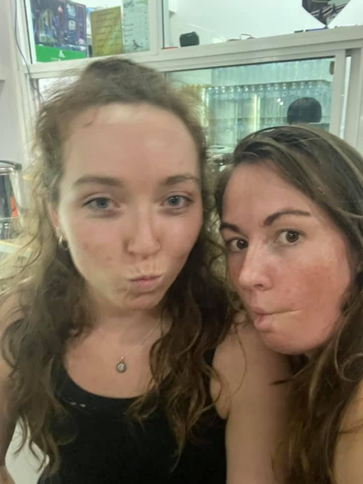 Two women are standing next to each other and making funny faces.