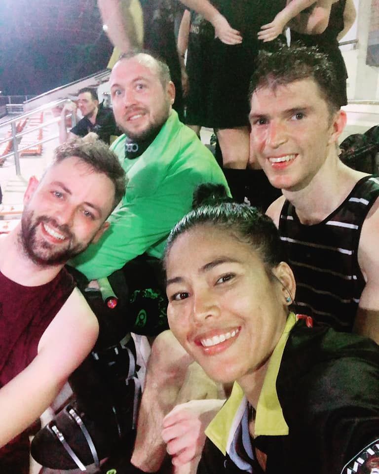 A group of people posing for a picture in a stadium