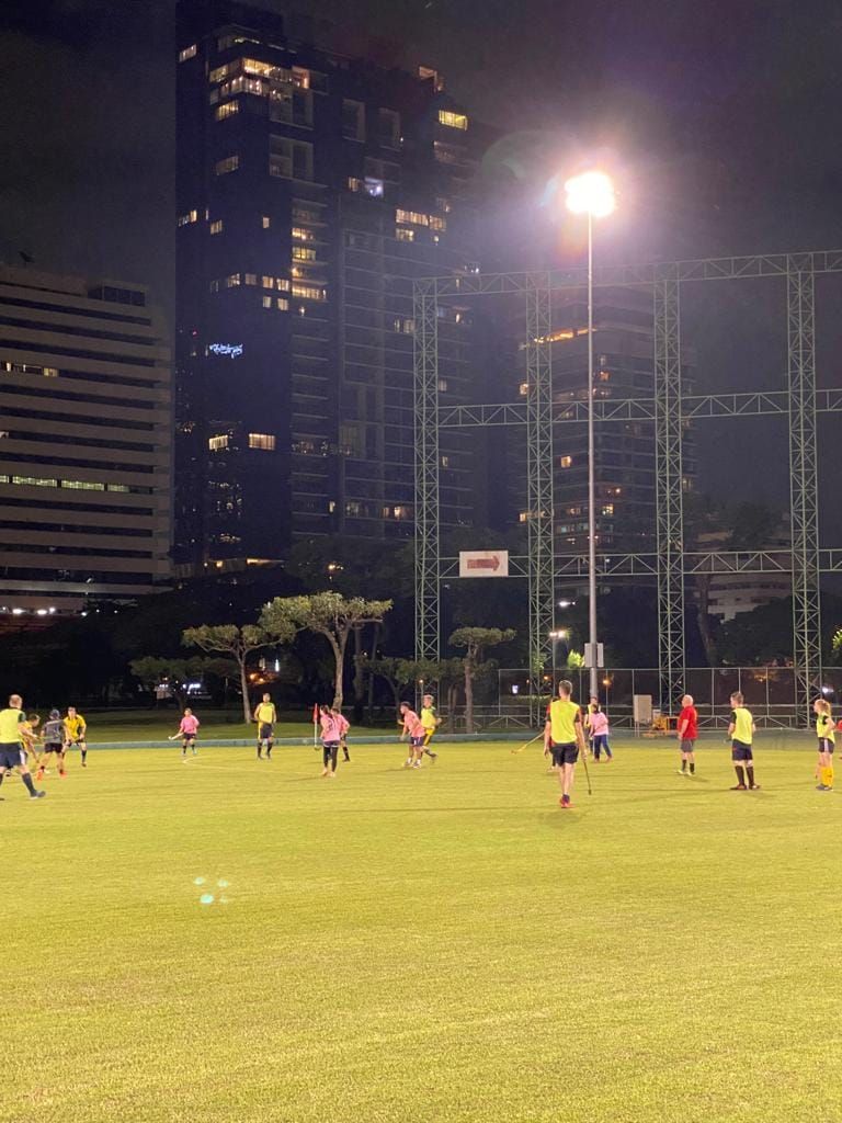A group of people are playing soccer on a field at night.