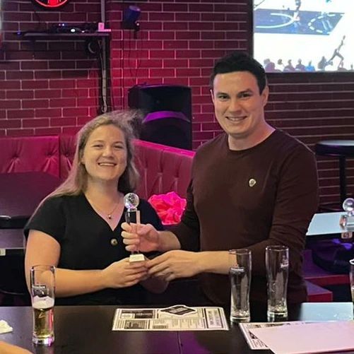 A man and a woman are sitting at a table in a restaurant.