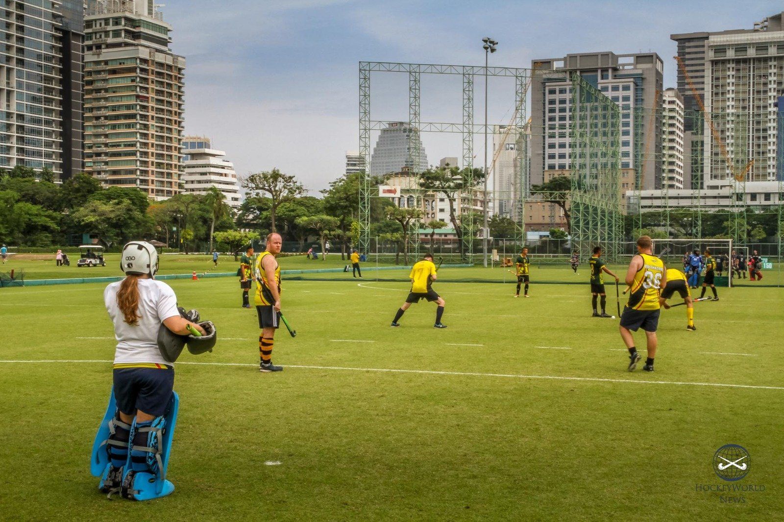 A group of people are playing a sport on a field
