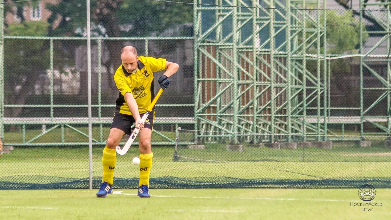 A man is playing field hockey on a field.
