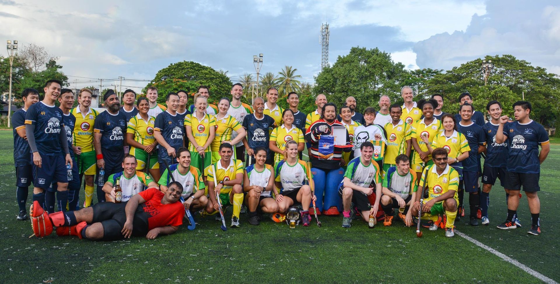 A group of soccer players are posing for a picture on a field.