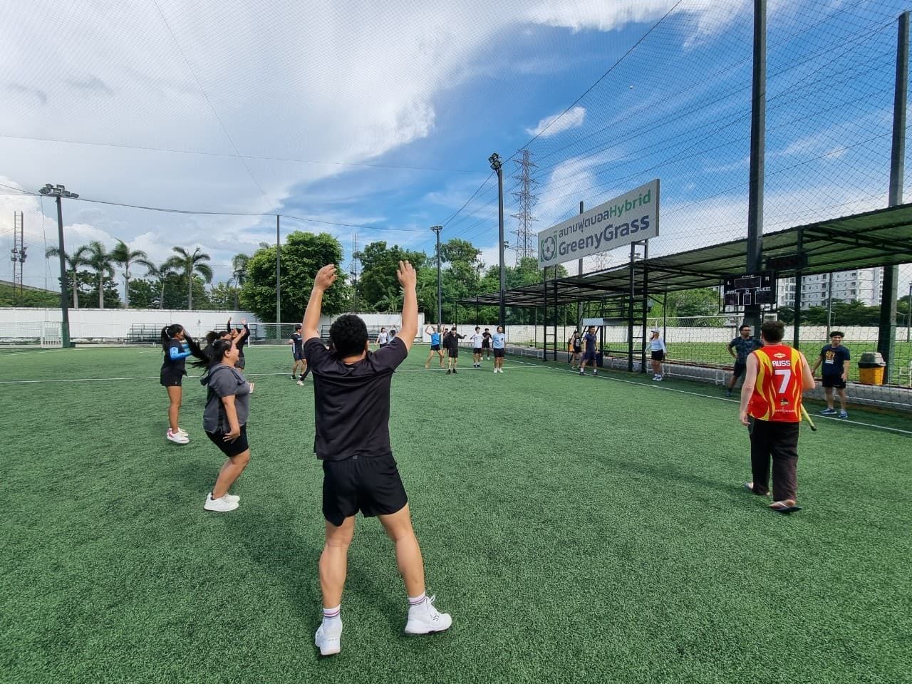 A group of people are standing on top of a soccer field.