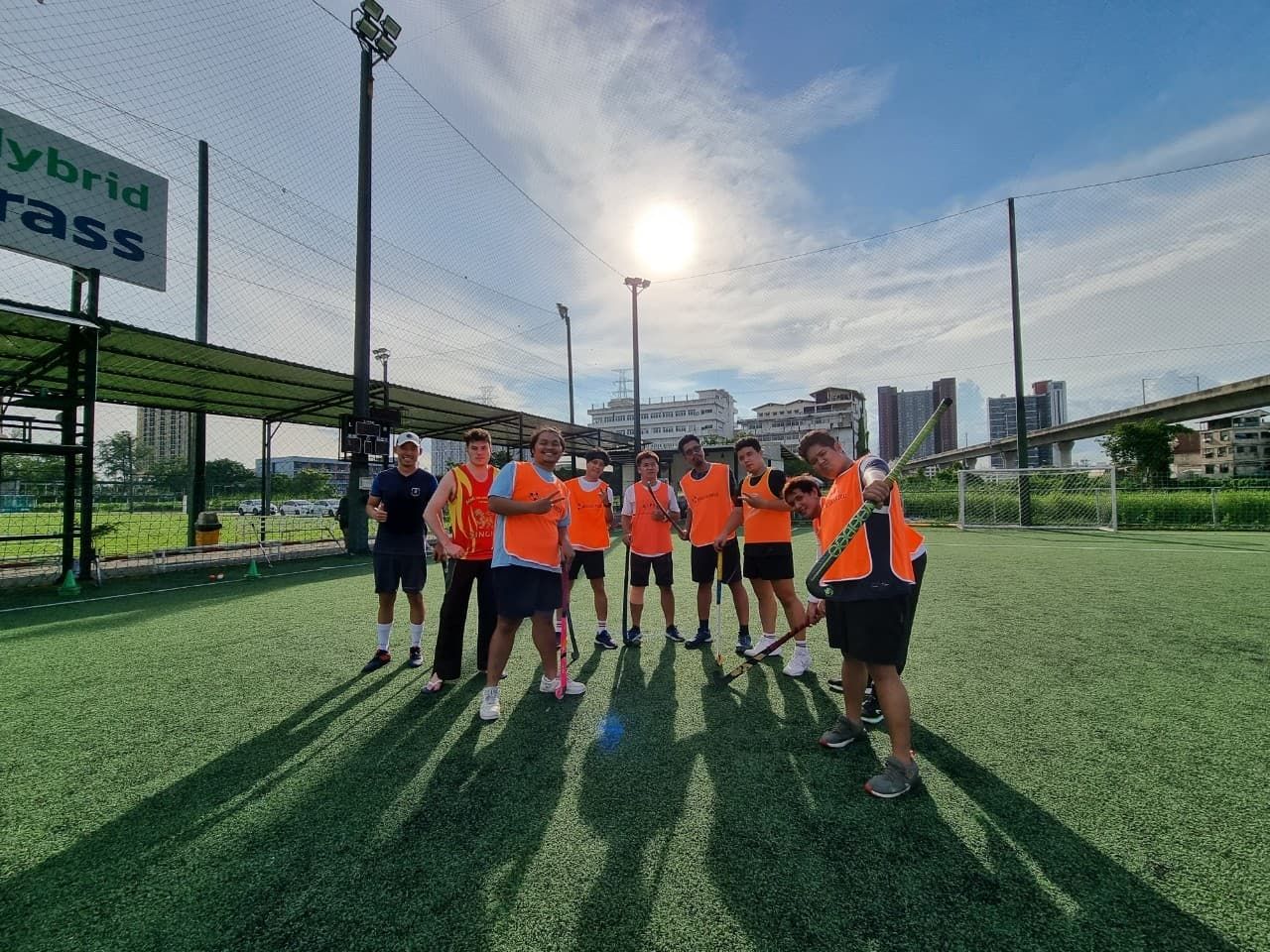 A group of people are posing for a picture on a soccer field.