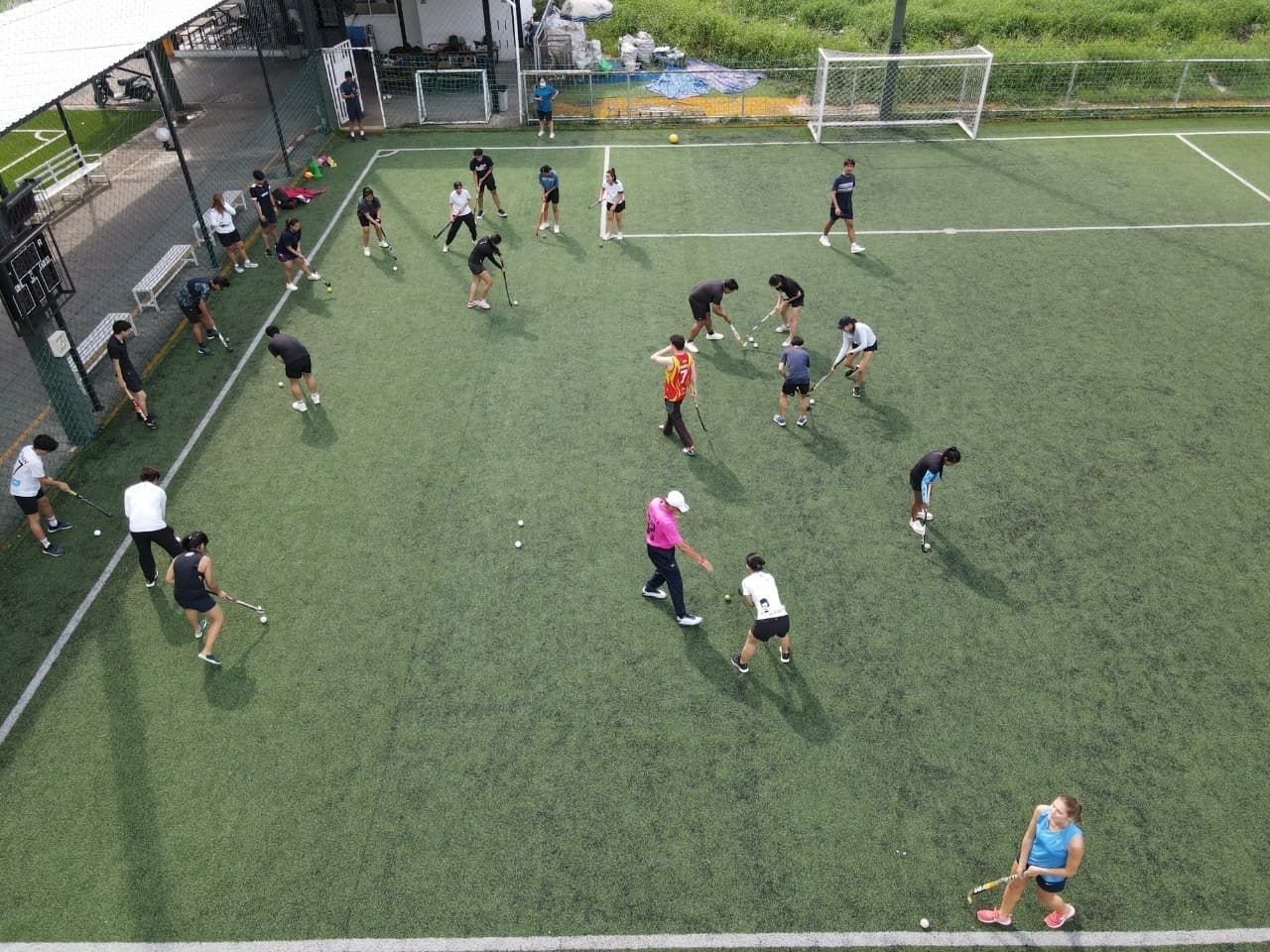 A group of people are playing soccer on a field.