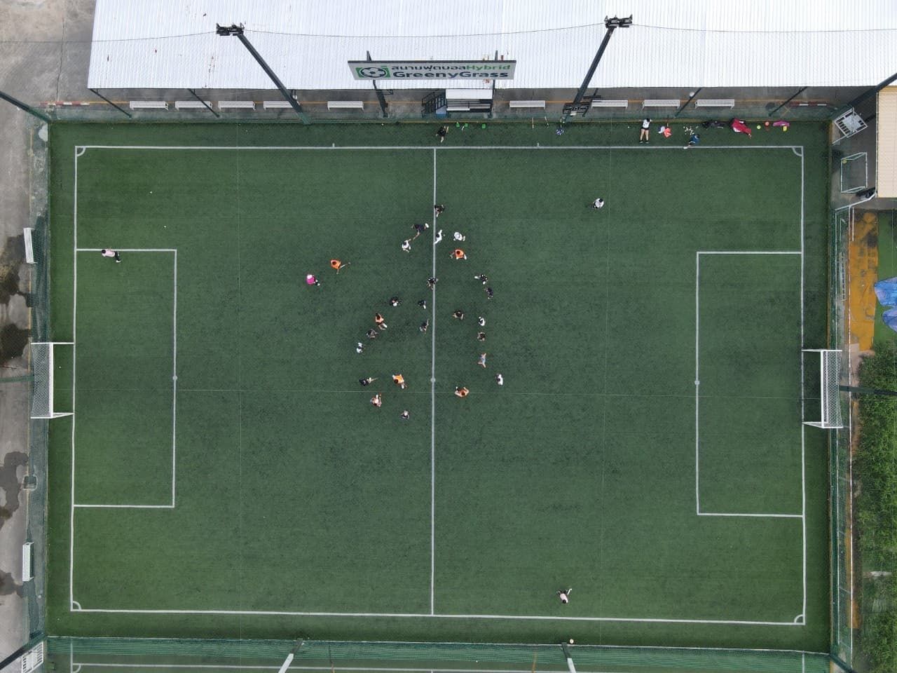 A group of people are playing soccer on a soccer field.