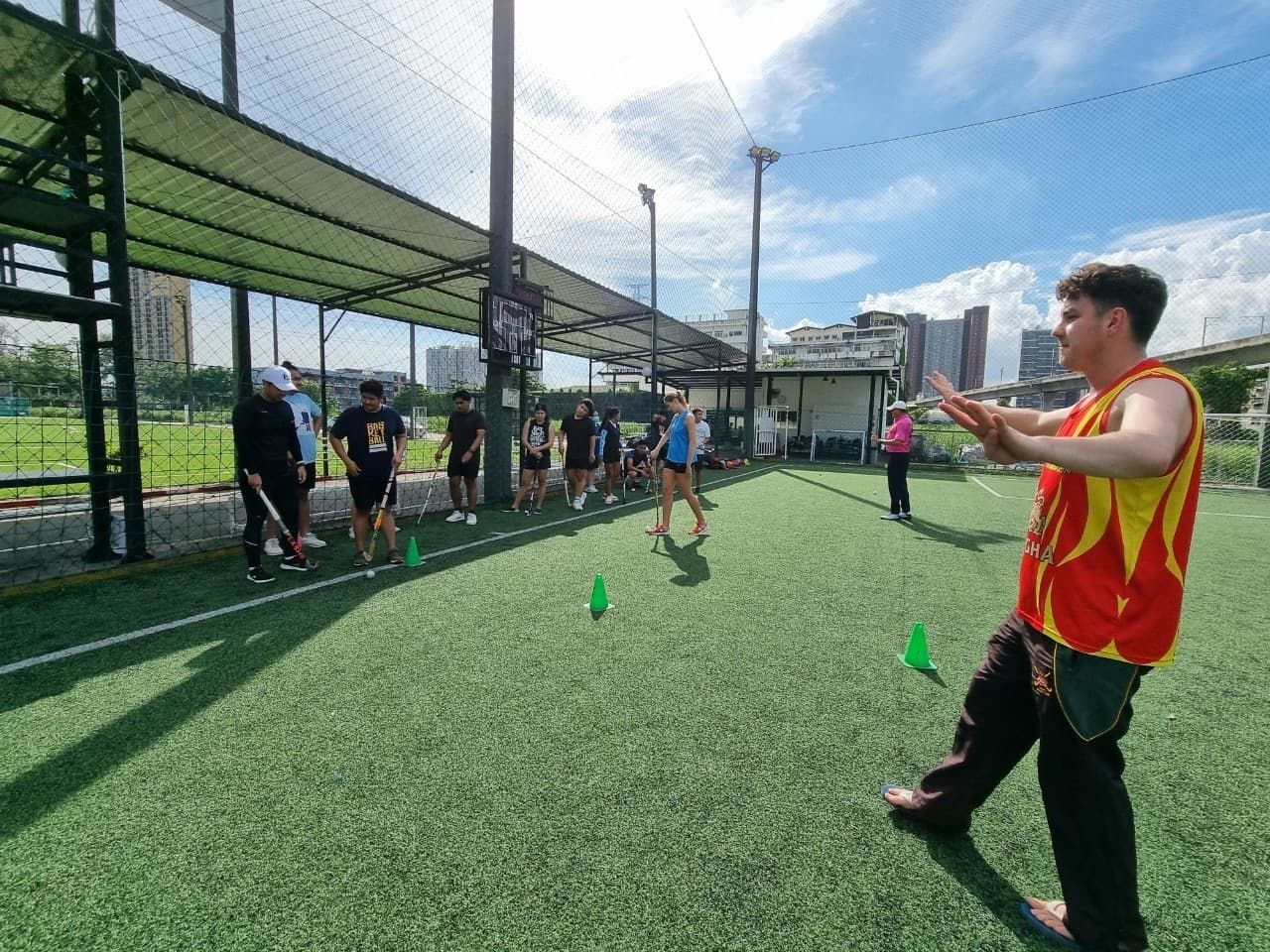 A group of people are standing on top of a soccer field.
