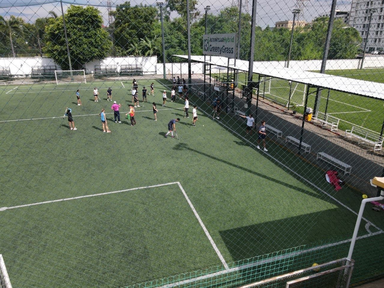 A group of people are playing soccer on a field.