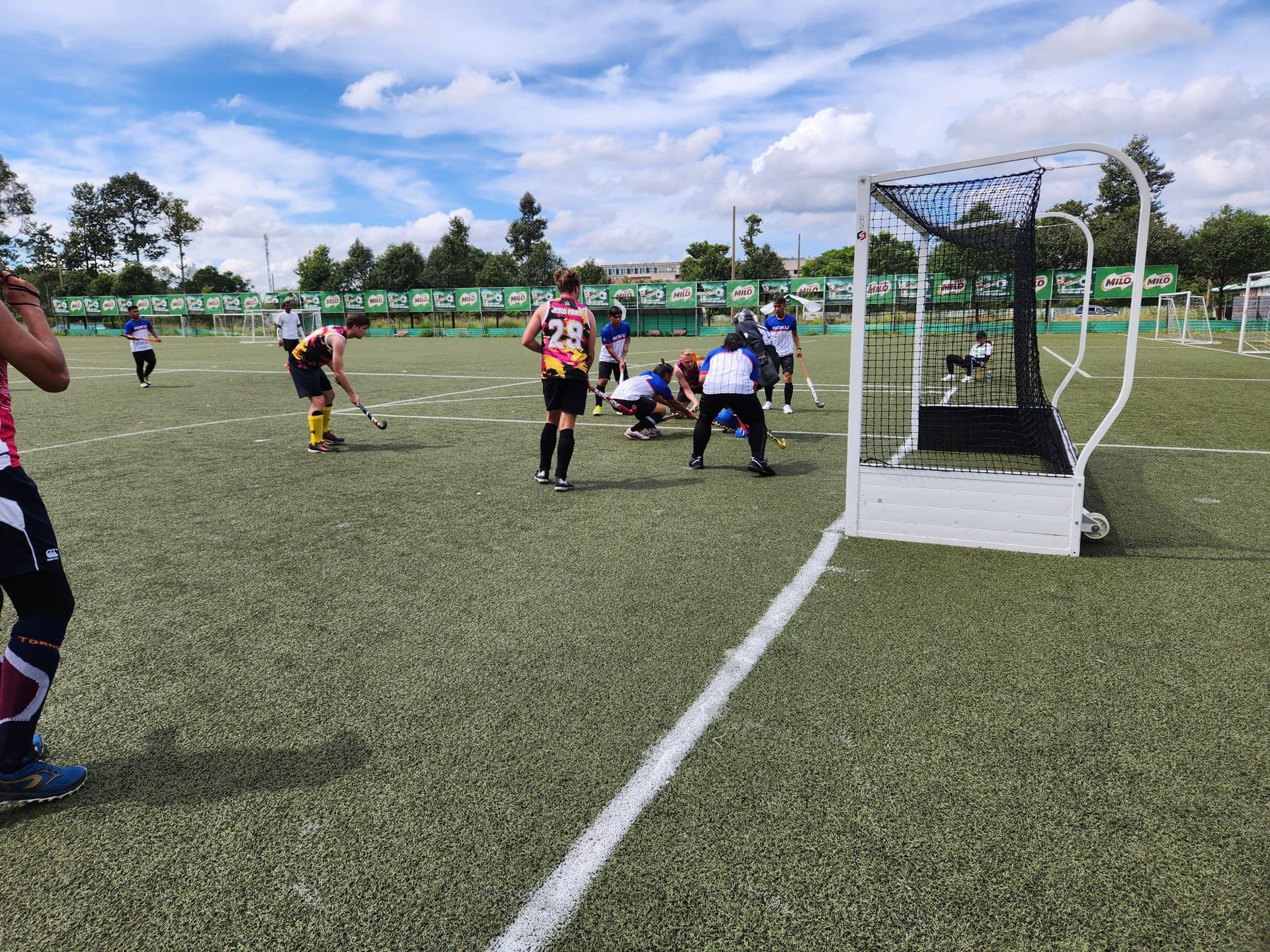 A group of people are playing soccer on a field.
