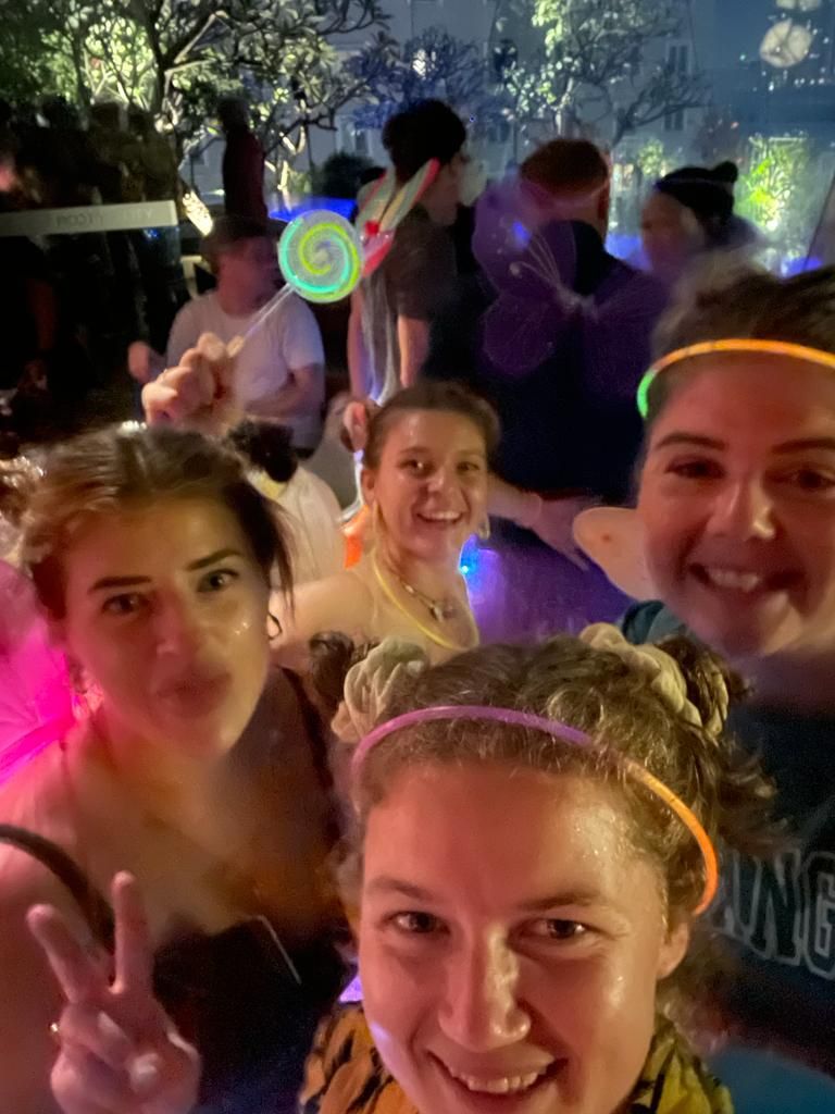 A group of women are posing for a picture at a party.