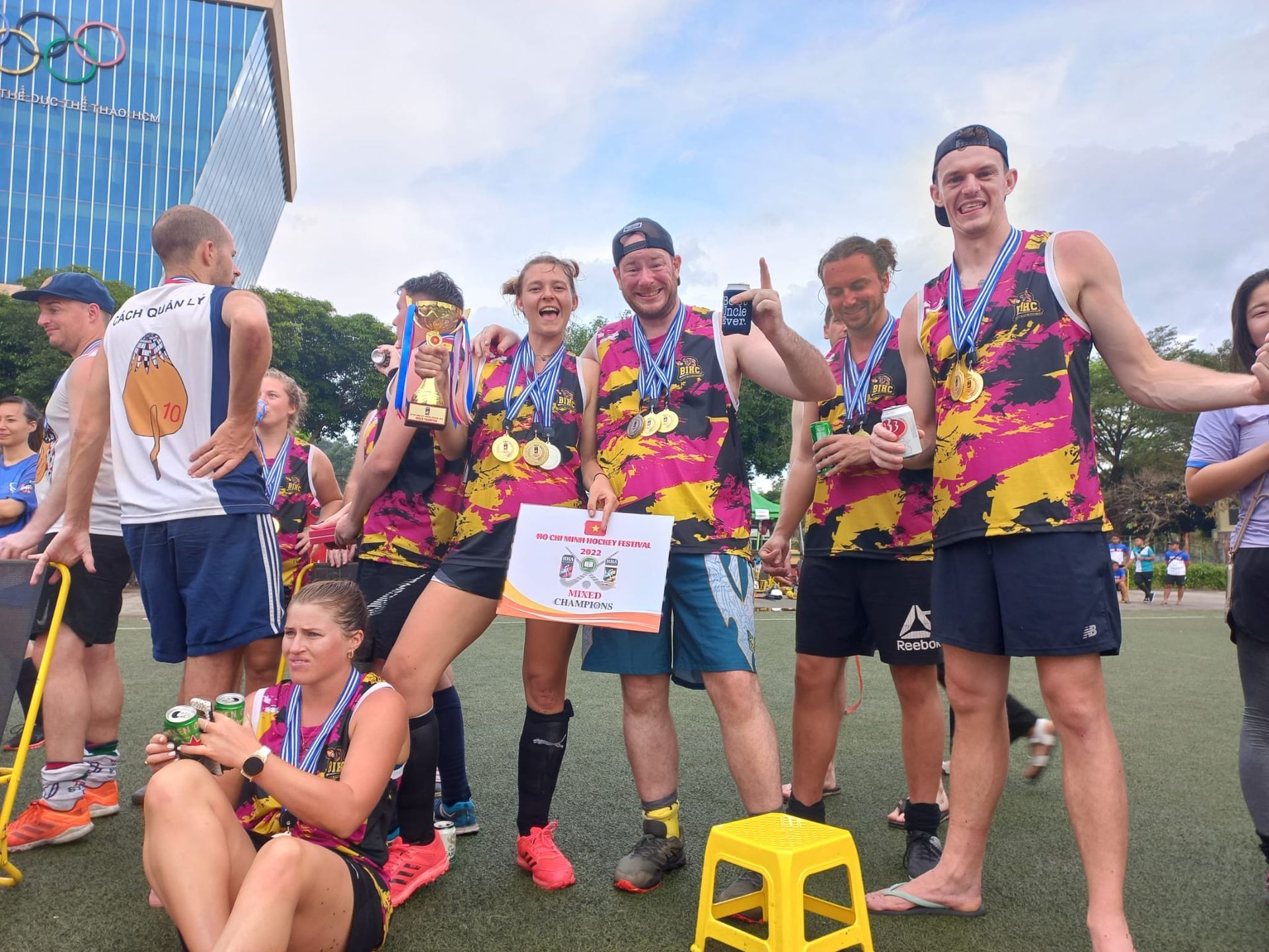 A group of people are posing for a picture on a field.