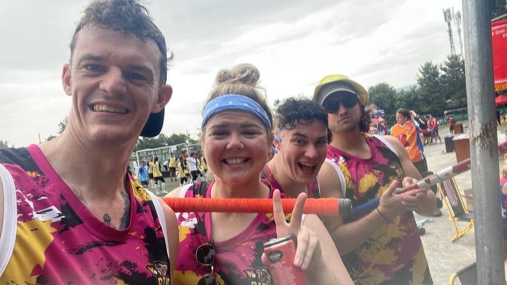 A group of people are standing next to each other and smiling.