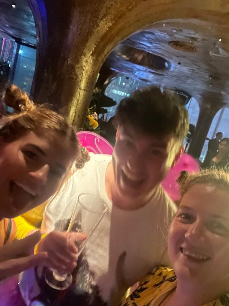 A group of people are posing for a picture in a restaurant.