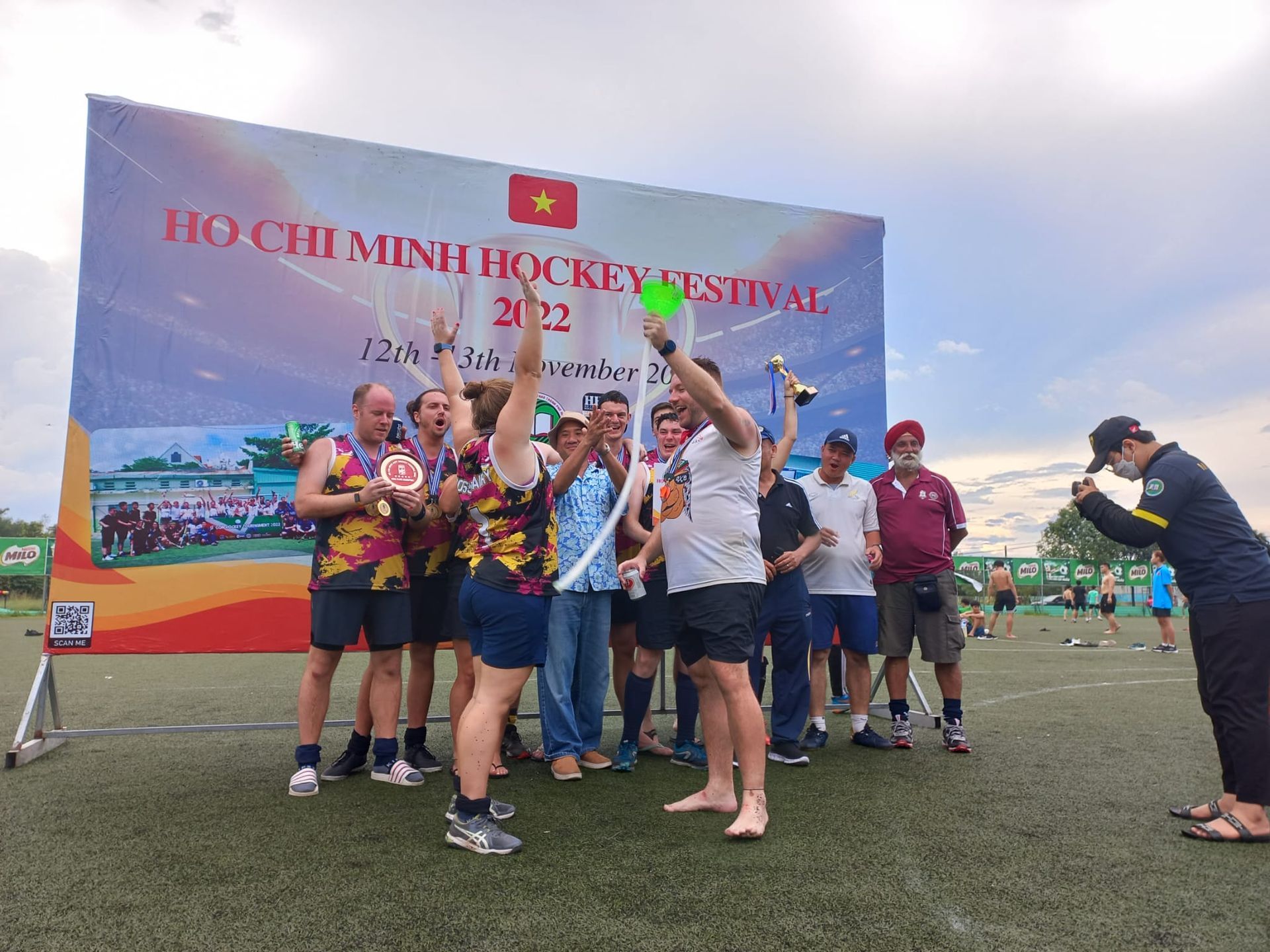 A group of people are posing for a picture on a field.
