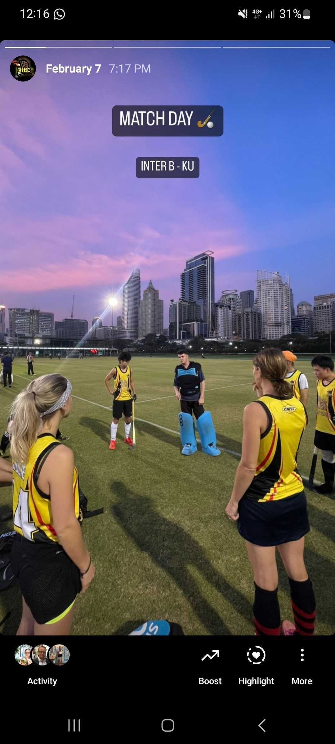A group of people standing on top of a soccer field.