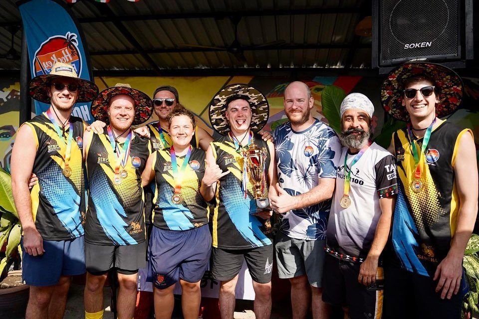 A group of people standing next to each other holding a trophy.