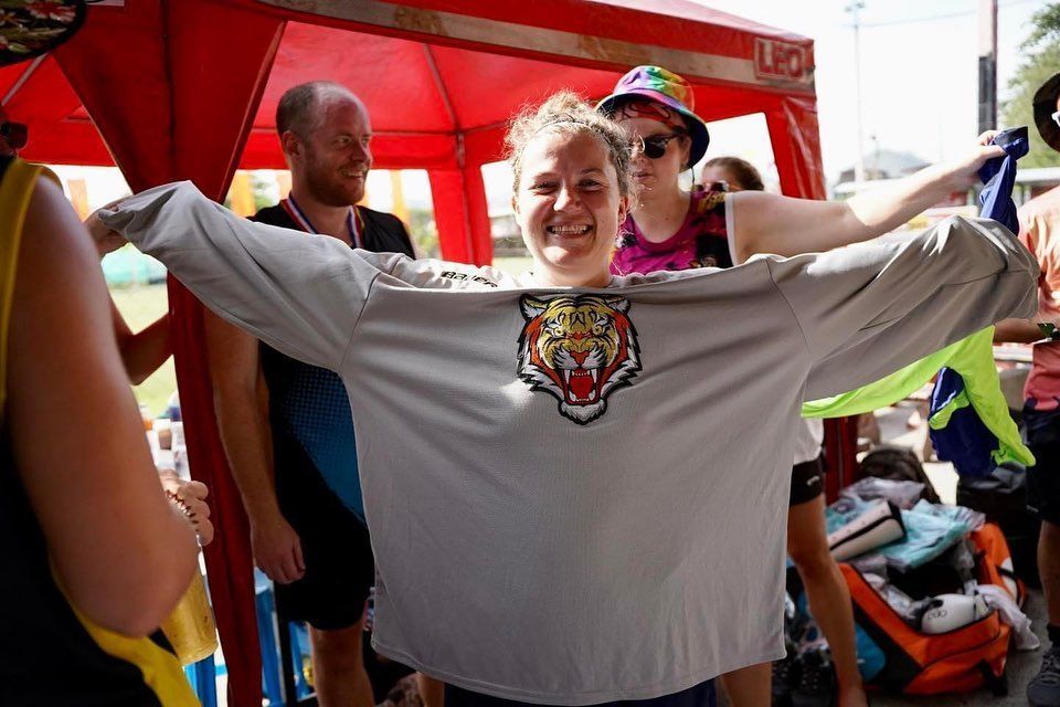 A woman is wearing a shirt with a tiger on it