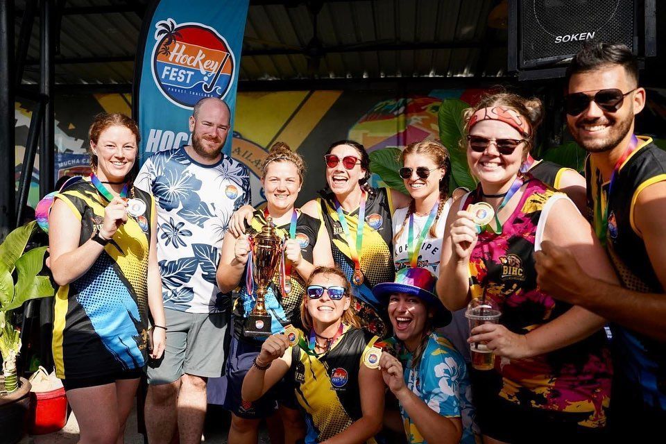 A group of people are posing for a picture at a festival.