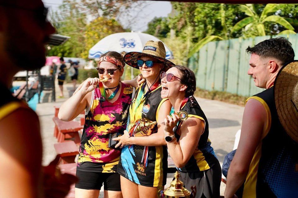 A group of people are posing for a picture in a park.