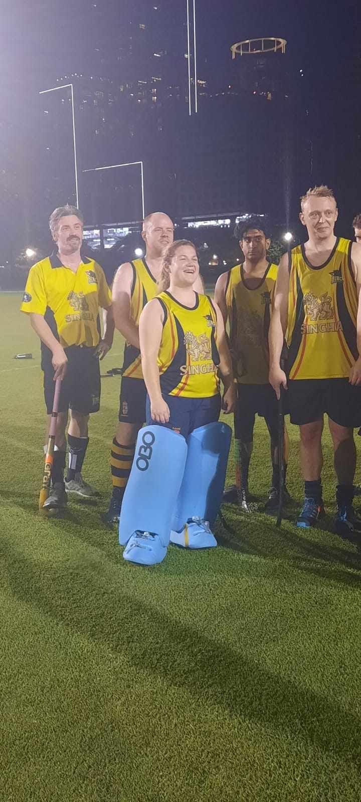 A group of men are standing on top of a soccer field.