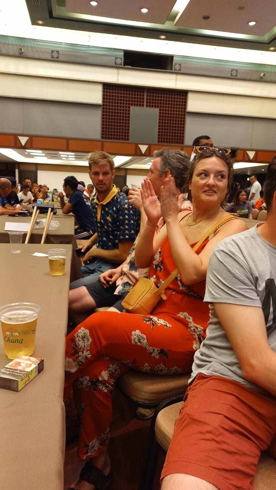A group of people are sitting at tables in a room.