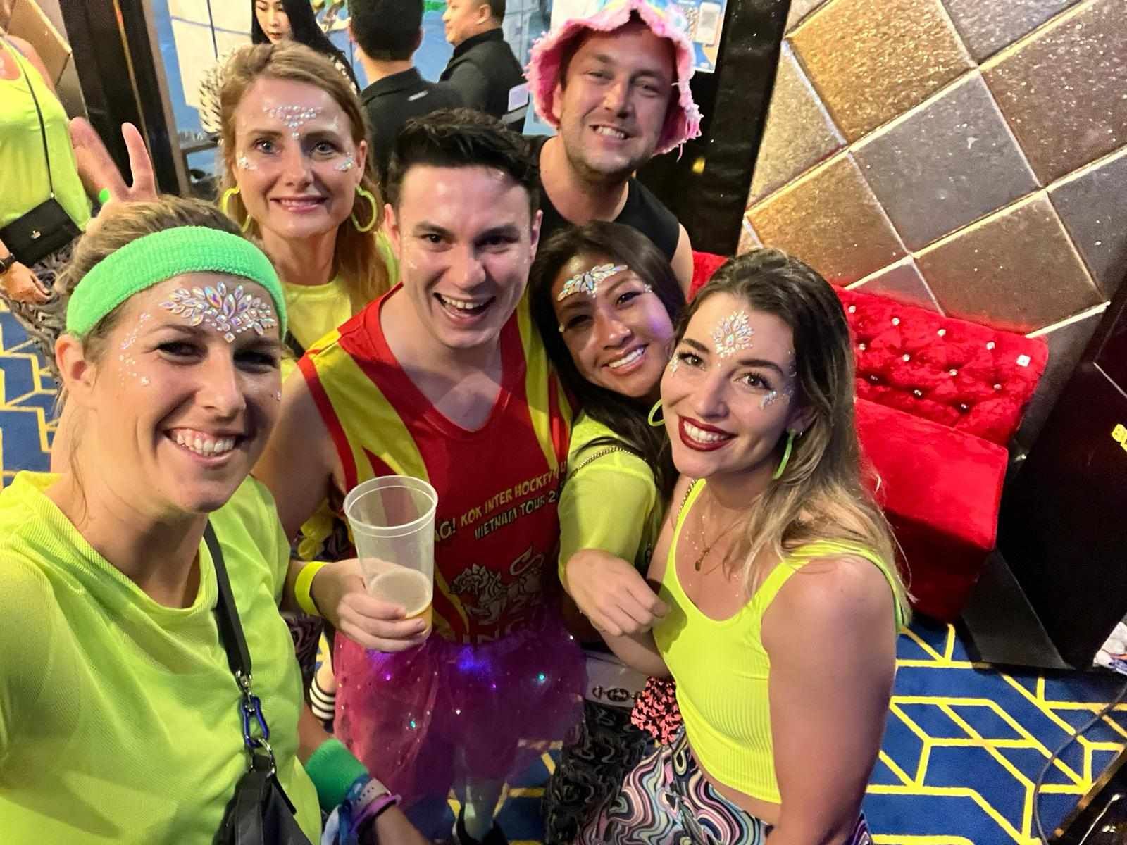 A group of people are posing for a picture at a party.