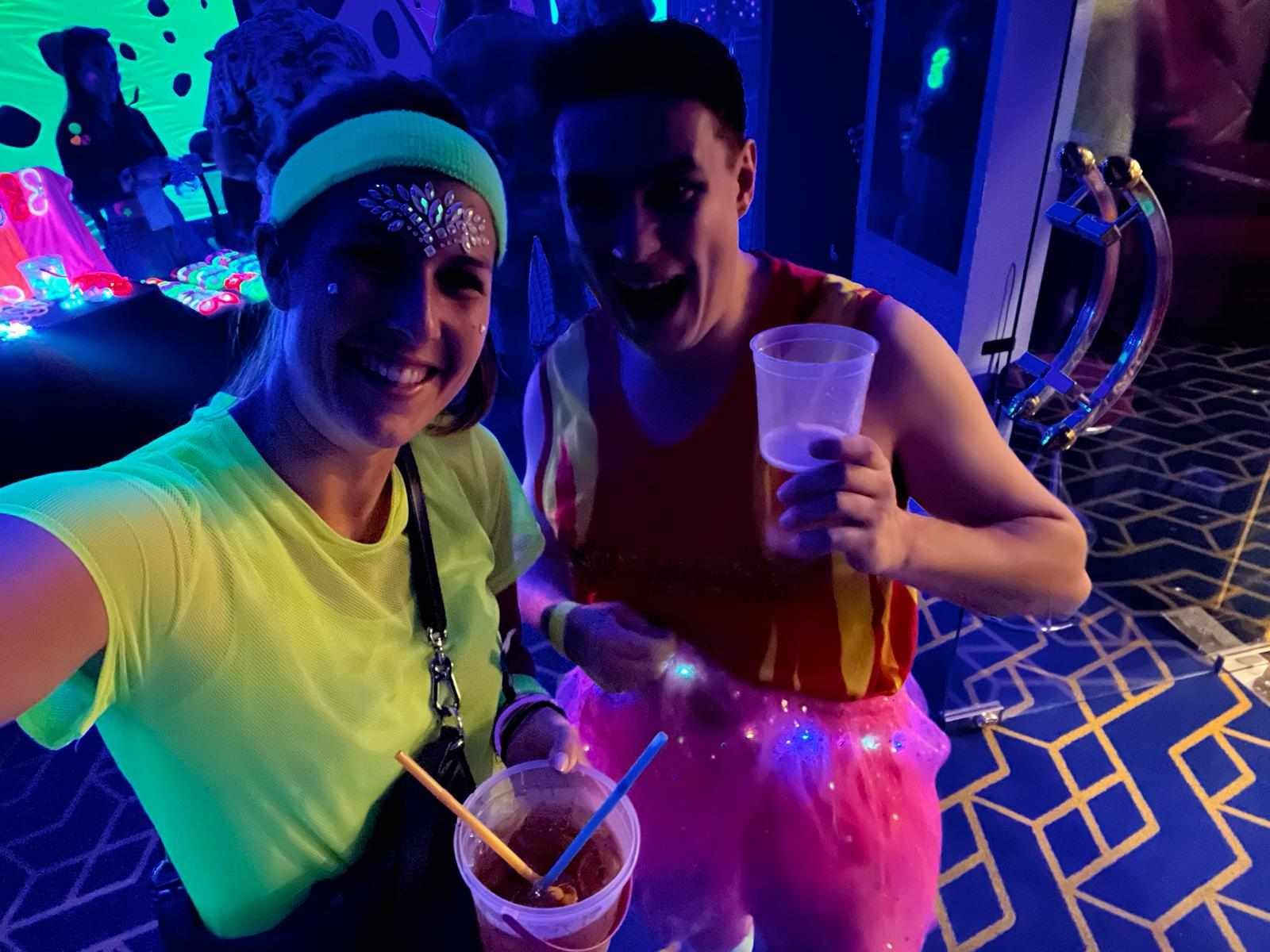 A man and a woman are standing next to each other in a dark room.