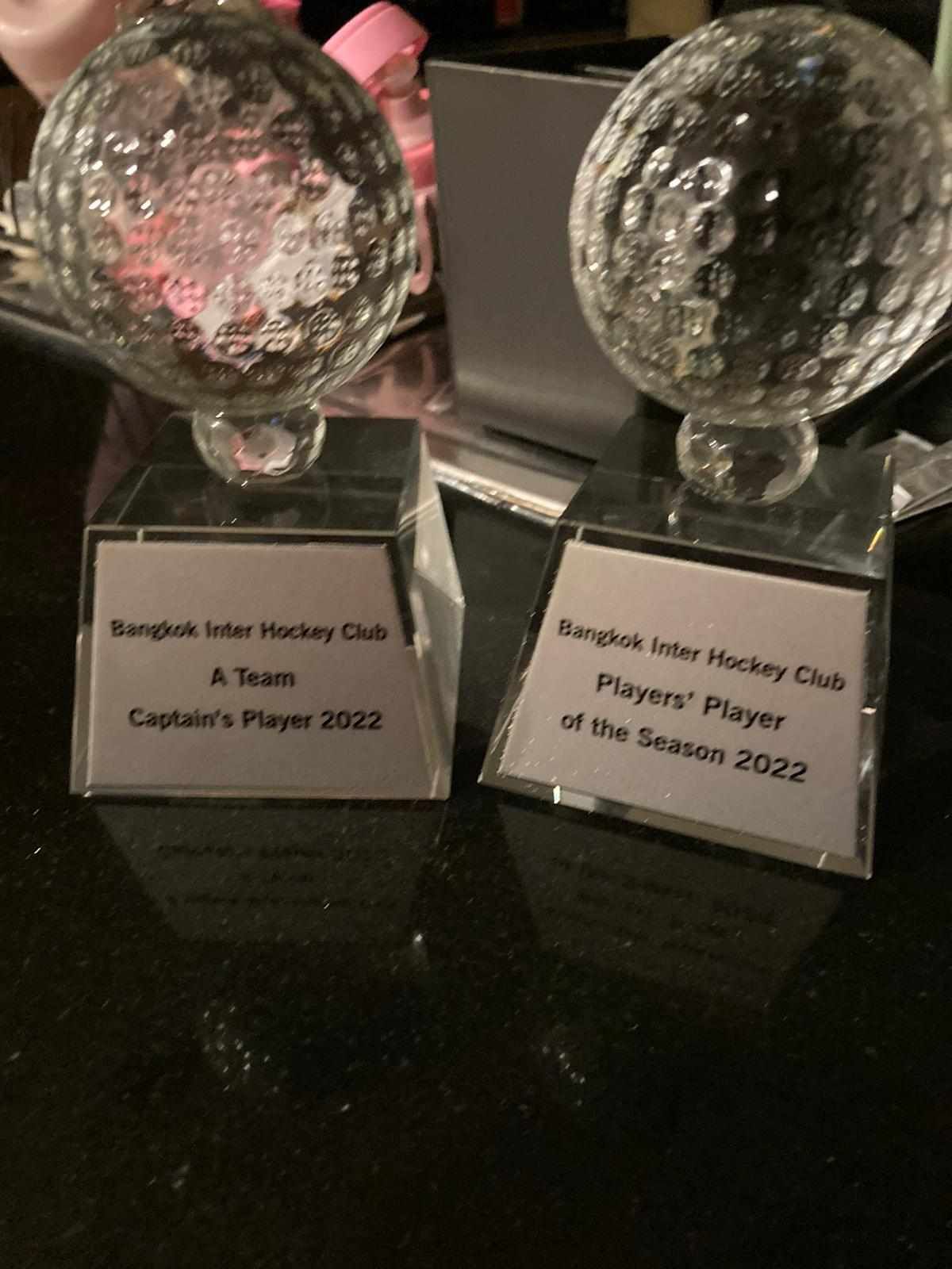 Two glass trophies for captain 's player and team player of the season