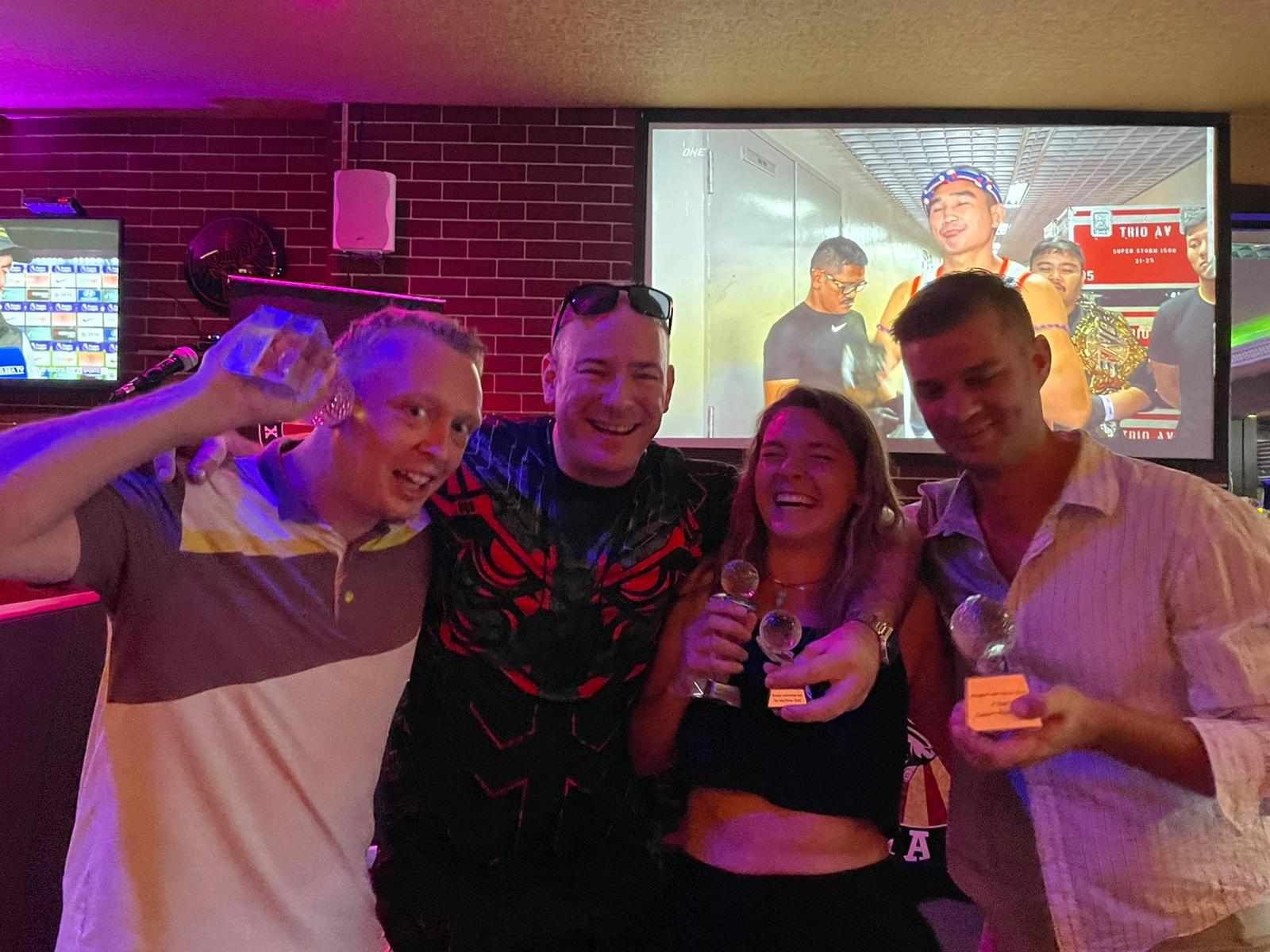 A group of people are posing for a picture in a bar.