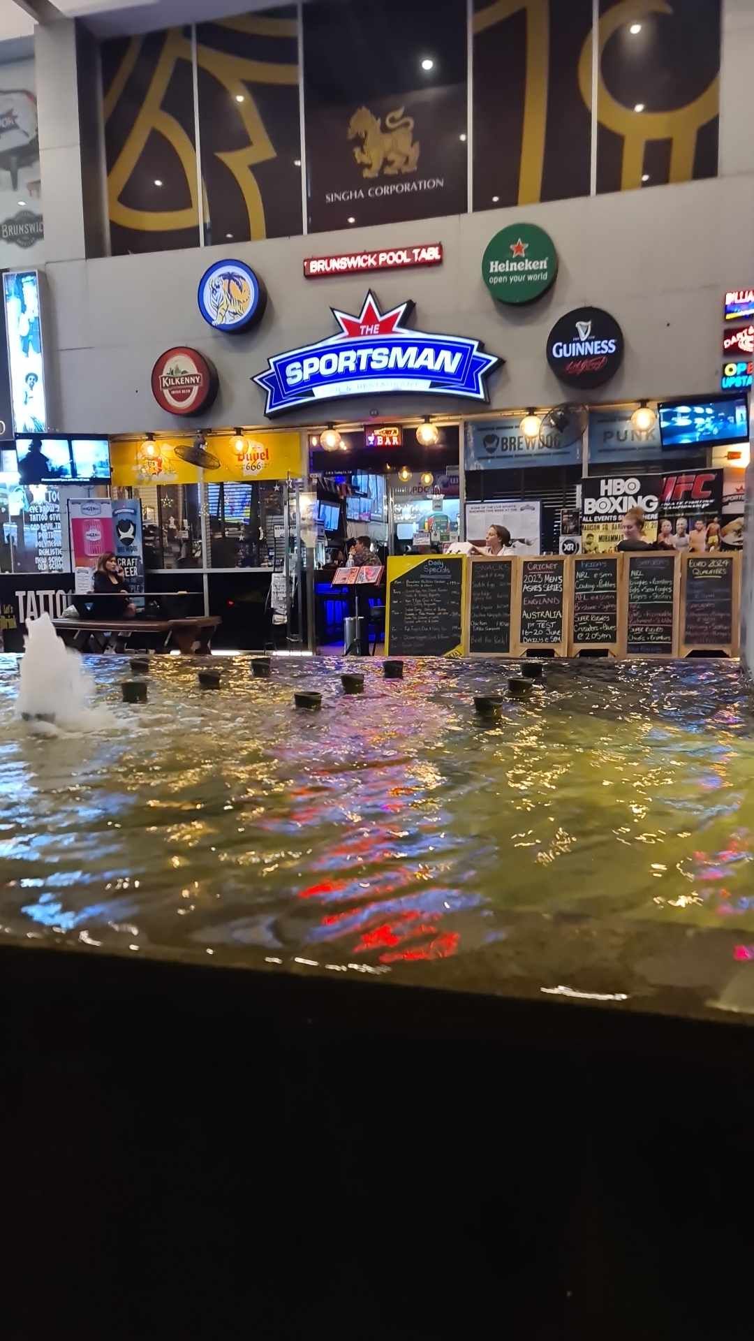 A restaurant with a fountain in the middle of it