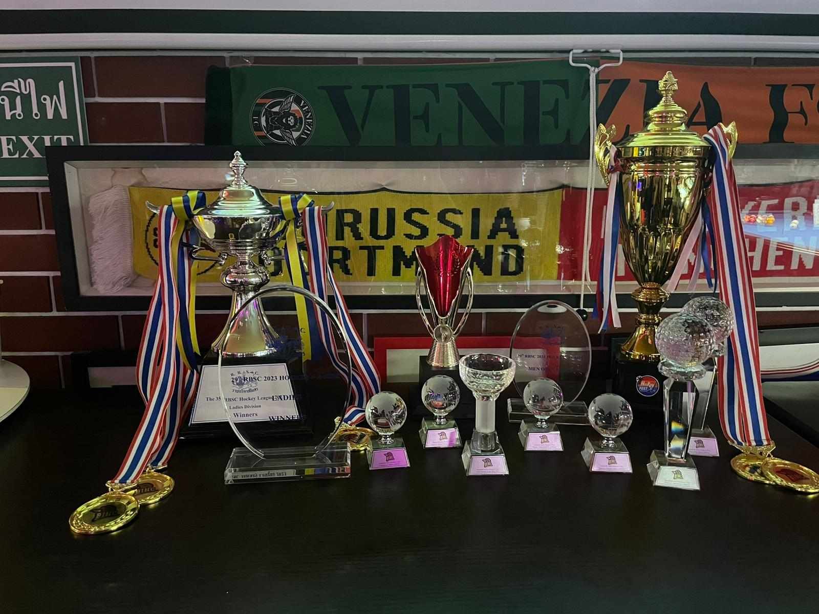 A bunch of trophies and medals are on a table