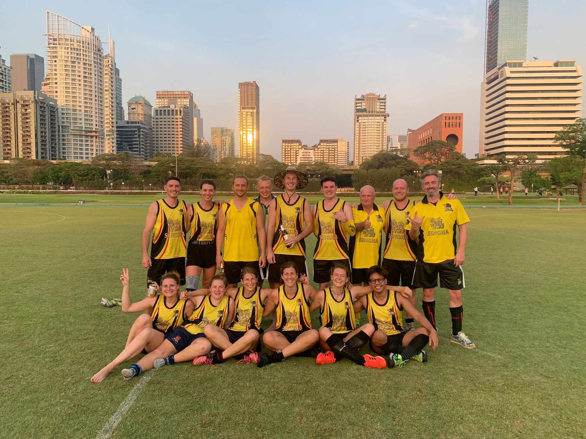 A group of people posing for a picture on a field