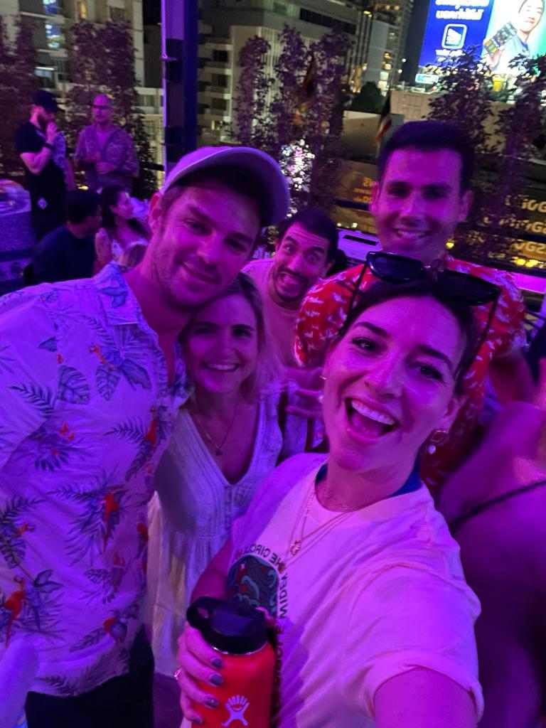 A group of people are posing for a selfie at a party.