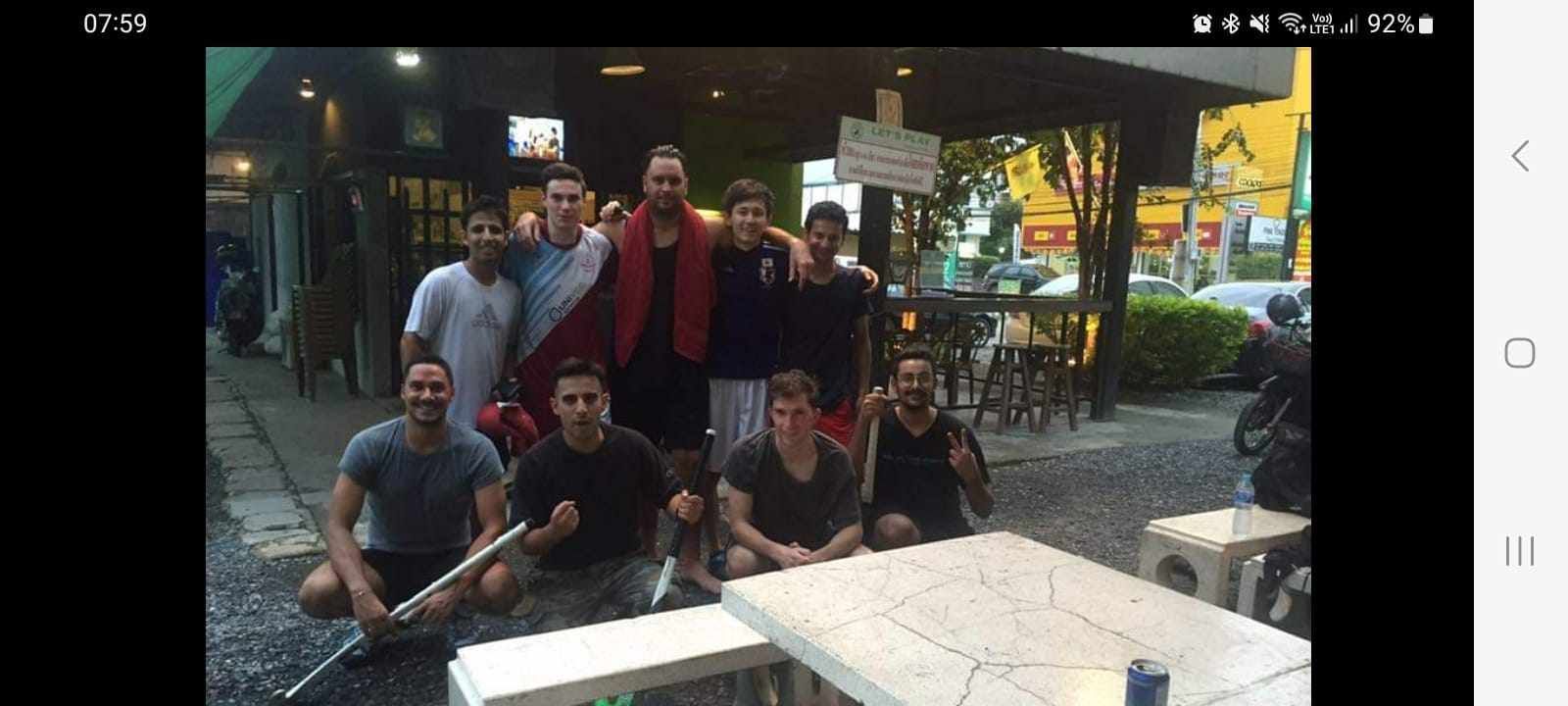 A group of men are posing for a picture in front of a table.