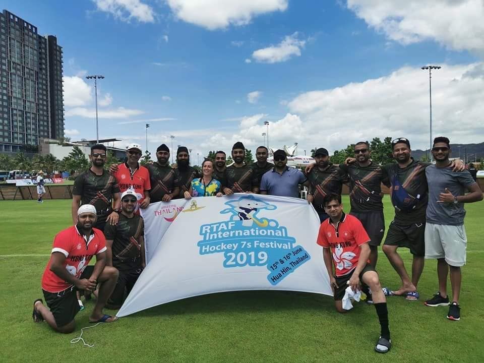 A group of men are posing for a picture while holding a banner that says 2019