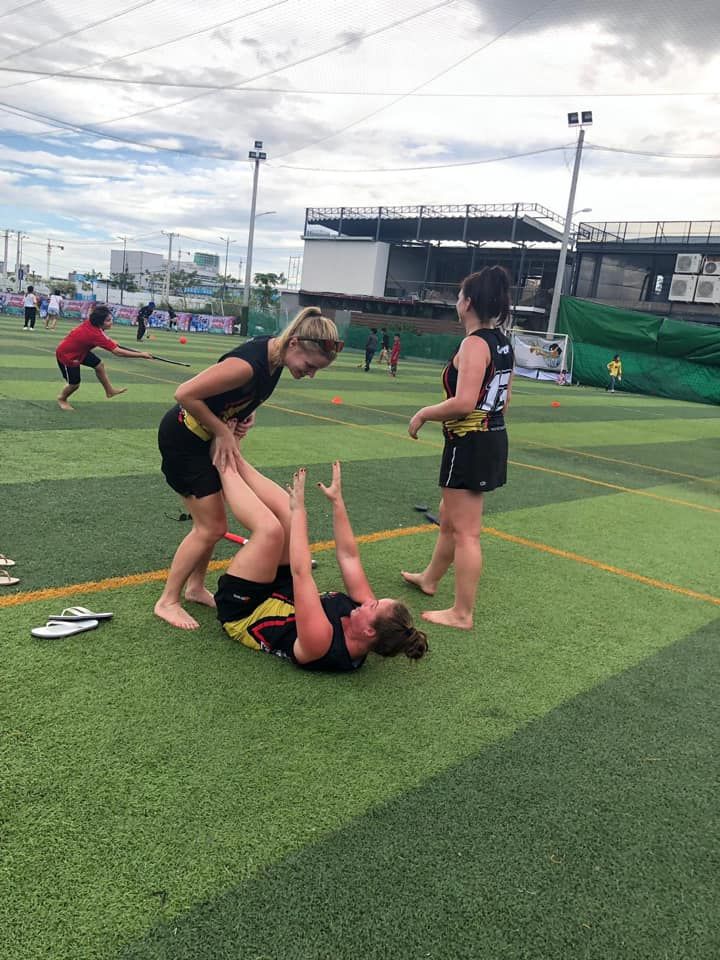 A group of women are playing soccer on a field.