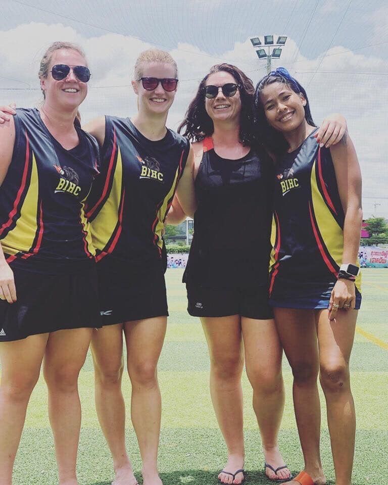 A group of women are posing for a picture with one wearing a shirt that says disc